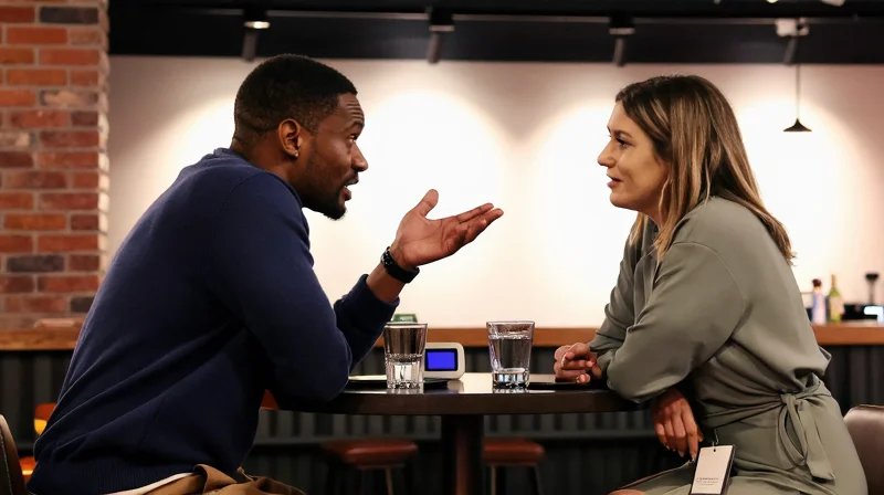 Two people mid-conversation at a speed dating event as a timer counts down